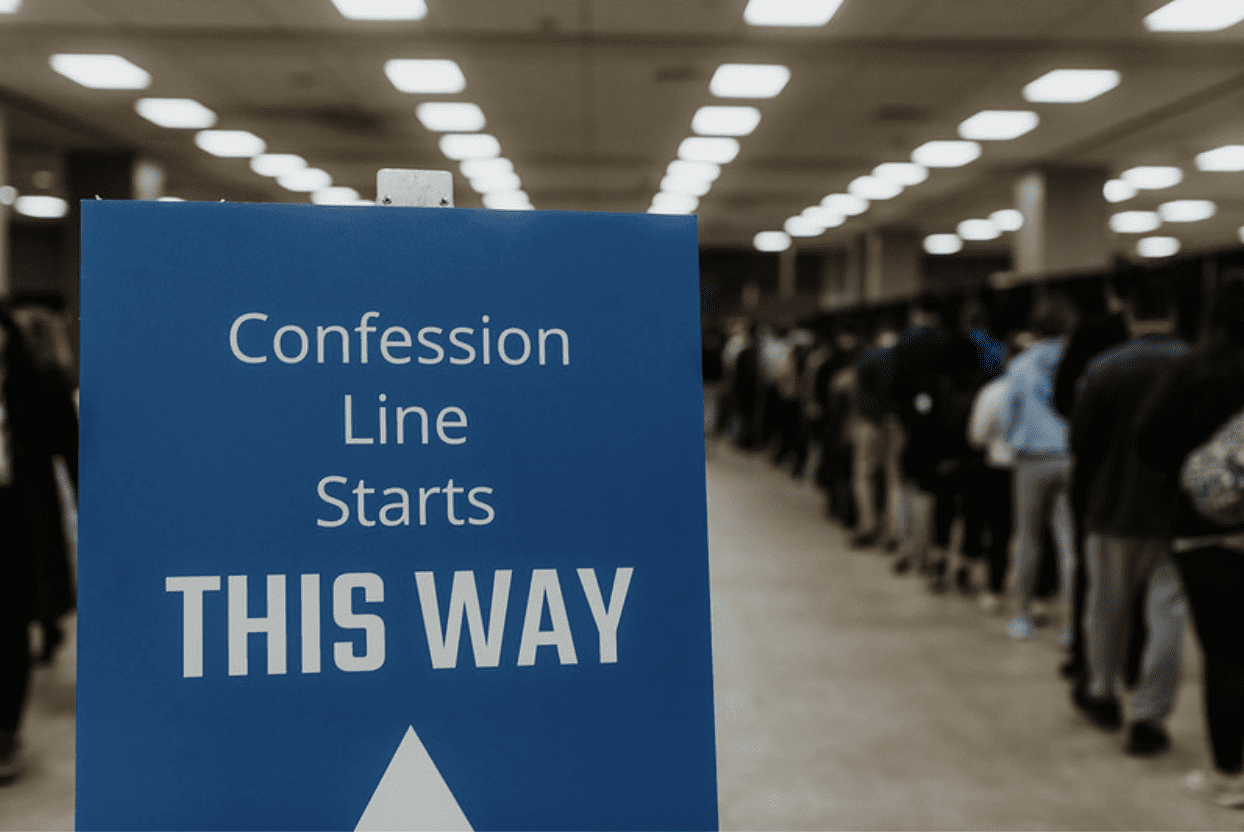 A sign indicates where the line for the sacrament of reconciliation starts. 